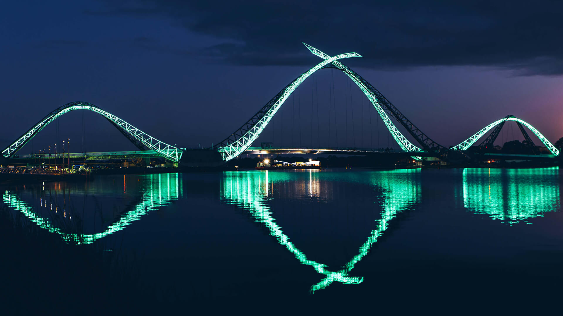 Matagarup Bridge lit at night over the Swan River